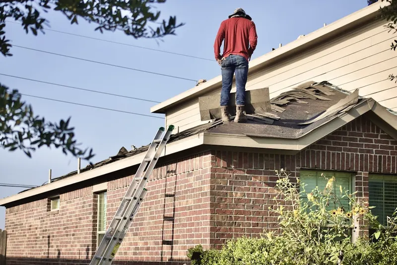Professional roofer working on a residential roof in Bay Port Colony
